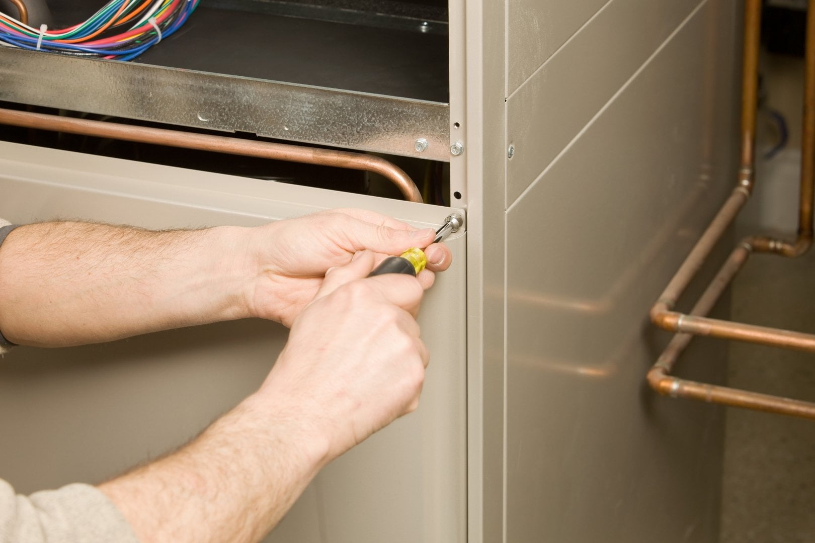 A man performing furnace replacement.