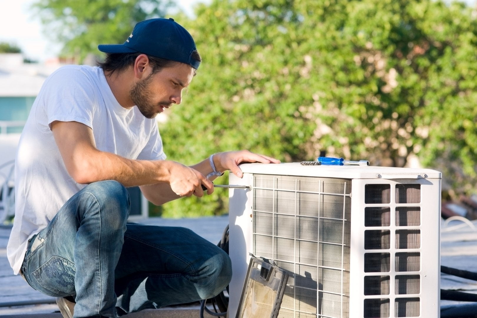 A man providing AC repair services on a roof.