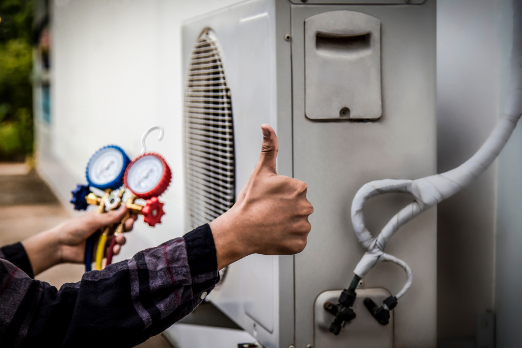 A man giving thumbs up to an eco-friendly air conditioner.