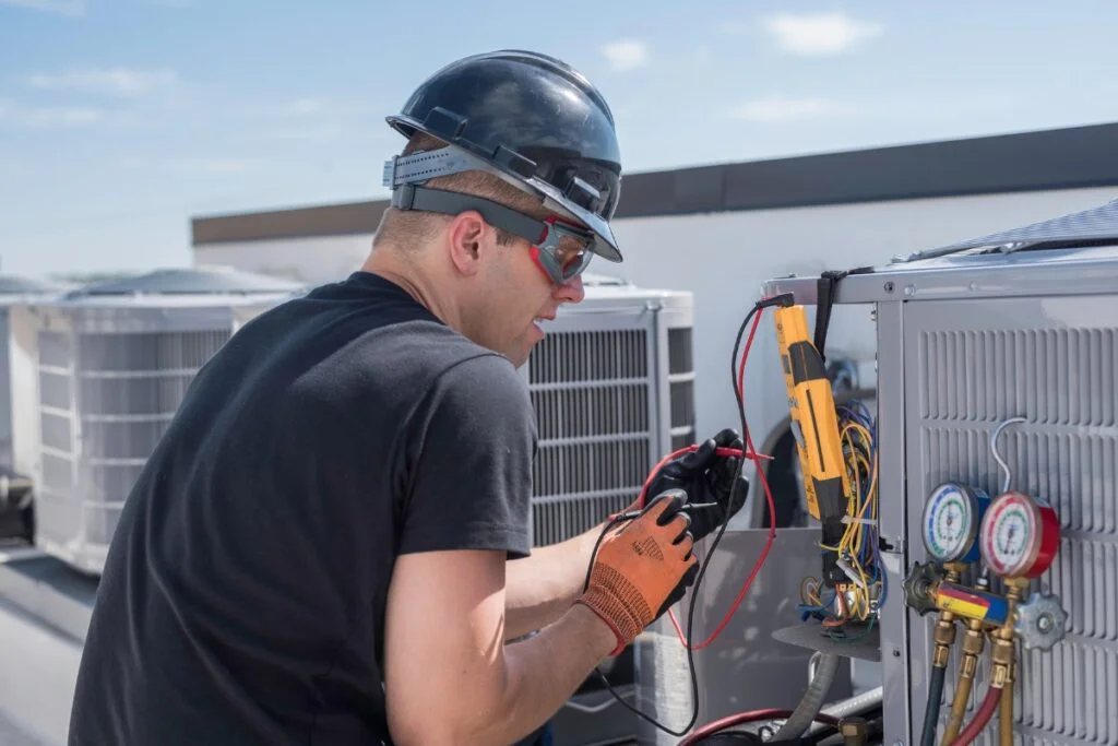 HVAC technician servicing an outdoor air conditioning unit for Georgia climate control.