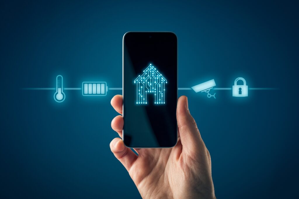 A hand holds a smartphone displaying a circuit board house icon against a dark background. Various smart home icons, including HVAC controls, a thermometer, battery, security camera, and padlock, surround the phone.