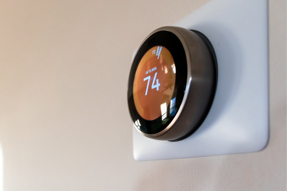 A smart thermostat is mounted on the wall, set to 74 degrees Fahrenheit, contributing to a healthy home through efficient HVAC management.