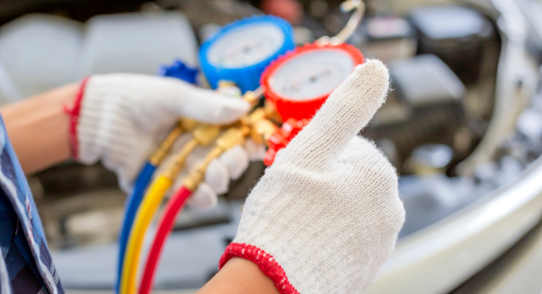 A man performing HVAC maintenance on a car.