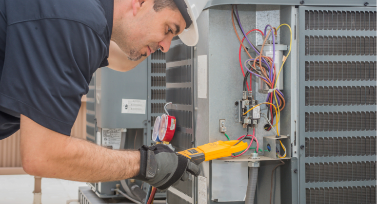 A man performing HVAC repair on an air conditioning unit.