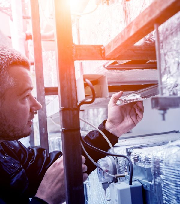 A man is servicing an air conditioning unit using a three-step process in a global row.