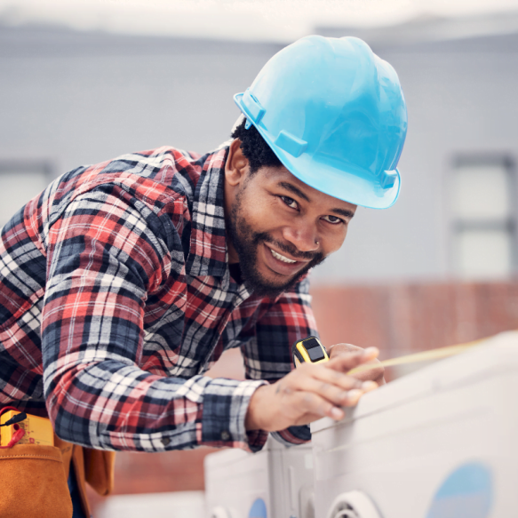 A construction worker wearing a hard hat assisting a Dallas HVAC Company.