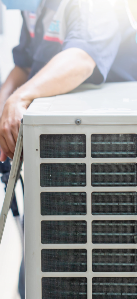 A man is repairing an air conditioning unit for a Dallas HVAC company.