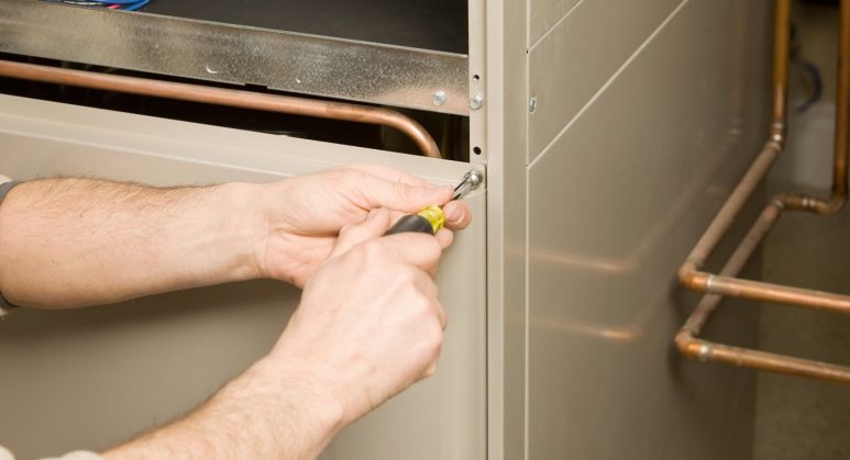 A man performing furnace replacement.