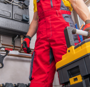 A technician from Hiram HVAC Company holding a toolbox.