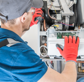 A Lawrenceville HVAC Company technician working on some HVAC maintenance.