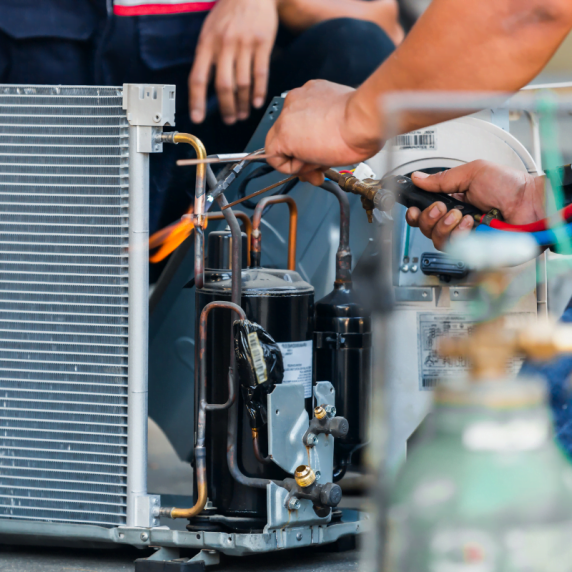 Two technicians performing HVAC maintenance in Marietta.